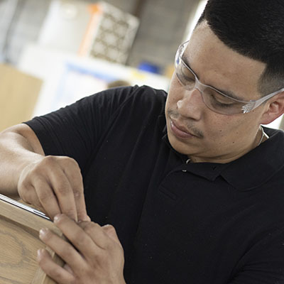 Technician installing custom cabinetry with attention to accuracy, efficiency, and long-term performance.