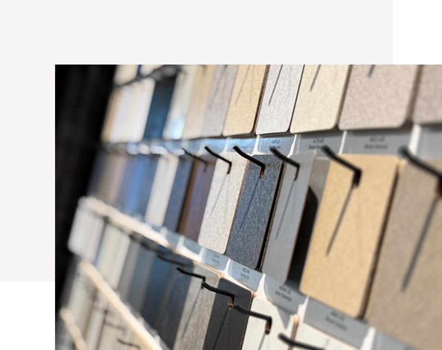 Wall display of material and color swatches in neutral tones, showcasing options for interior design and finish selection.